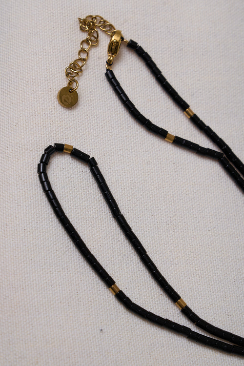 Stone Round Necklace - Black with small black beads and gold accents, featuring a gold clasp and adjustable chain for a refined look.