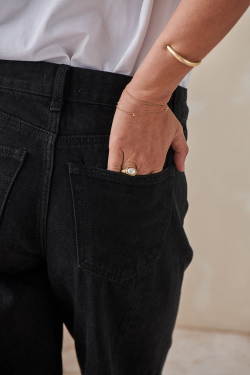 Mid Rise Barrel Jean - Black in rigid denim with a fitted hip and curved leg shape for a laid-back wardrobe update.