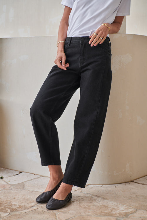 Mid Rise Barrel Jean - Black in rigid denim with a fitted hip and softly rounded leg for a casual, modern vibe.