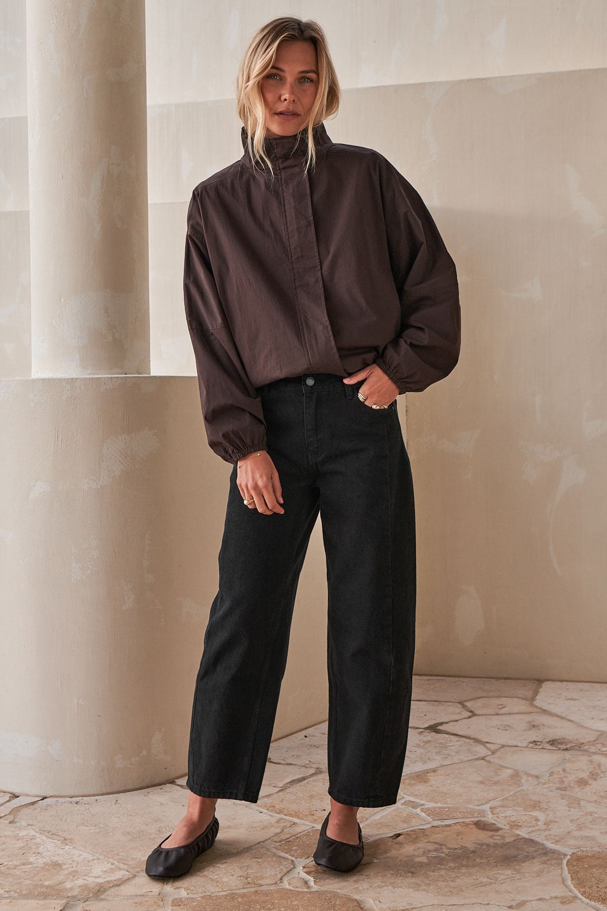 Mid Rise Barrel Jean - Black in rigid denim with a fitted hip and gently rounded leg for a sleek, modern silhouette.