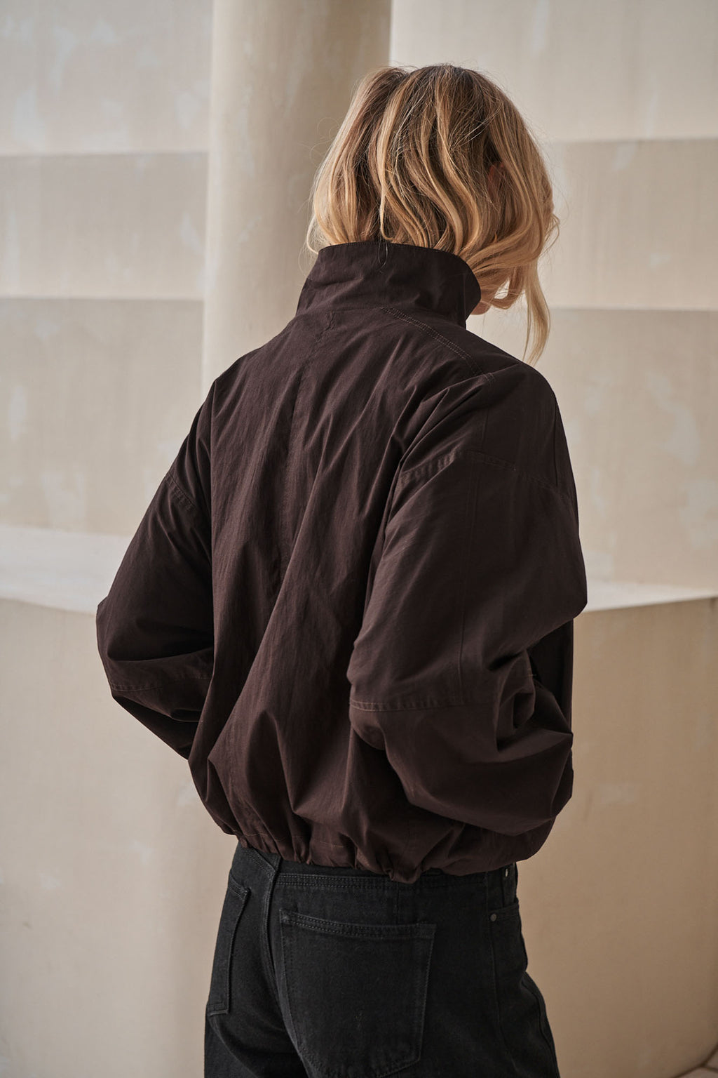 Nylon Track Jacket - Chocolate in a relaxed fit with a high collar and elasticated hem for easy layering.