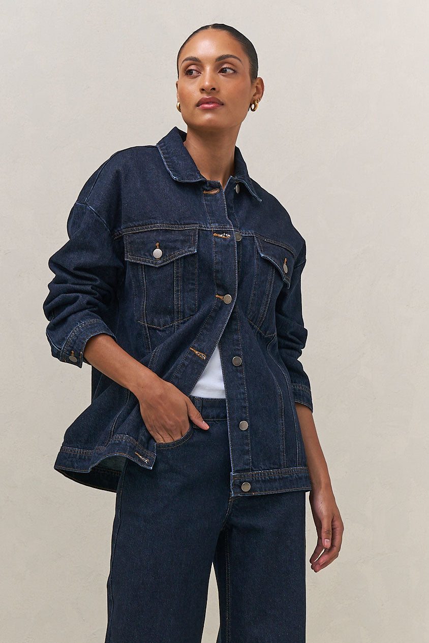 Denim Trucker Jacket - Indigo in rigid denim with a clean silhouette and structured fit for timeless layering.