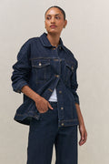 Denim Trucker Jacket - Indigo in rigid denim with a clean silhouette and structured fit for timeless layering.