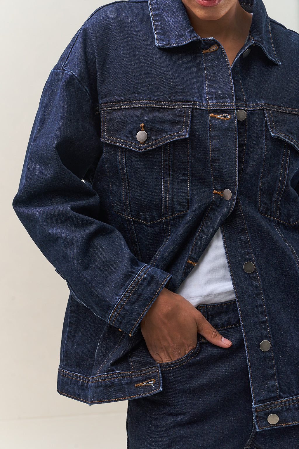 Denim Trucker Jacket - Indigo in rigid denim with a clean silhouette and structured fit that layers easily over knits.