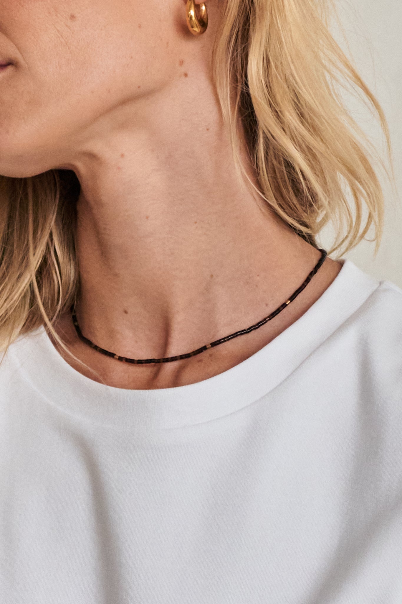 Stone Round Necklace - Dark Brown with small round beads creating a delicate, minimalist look.