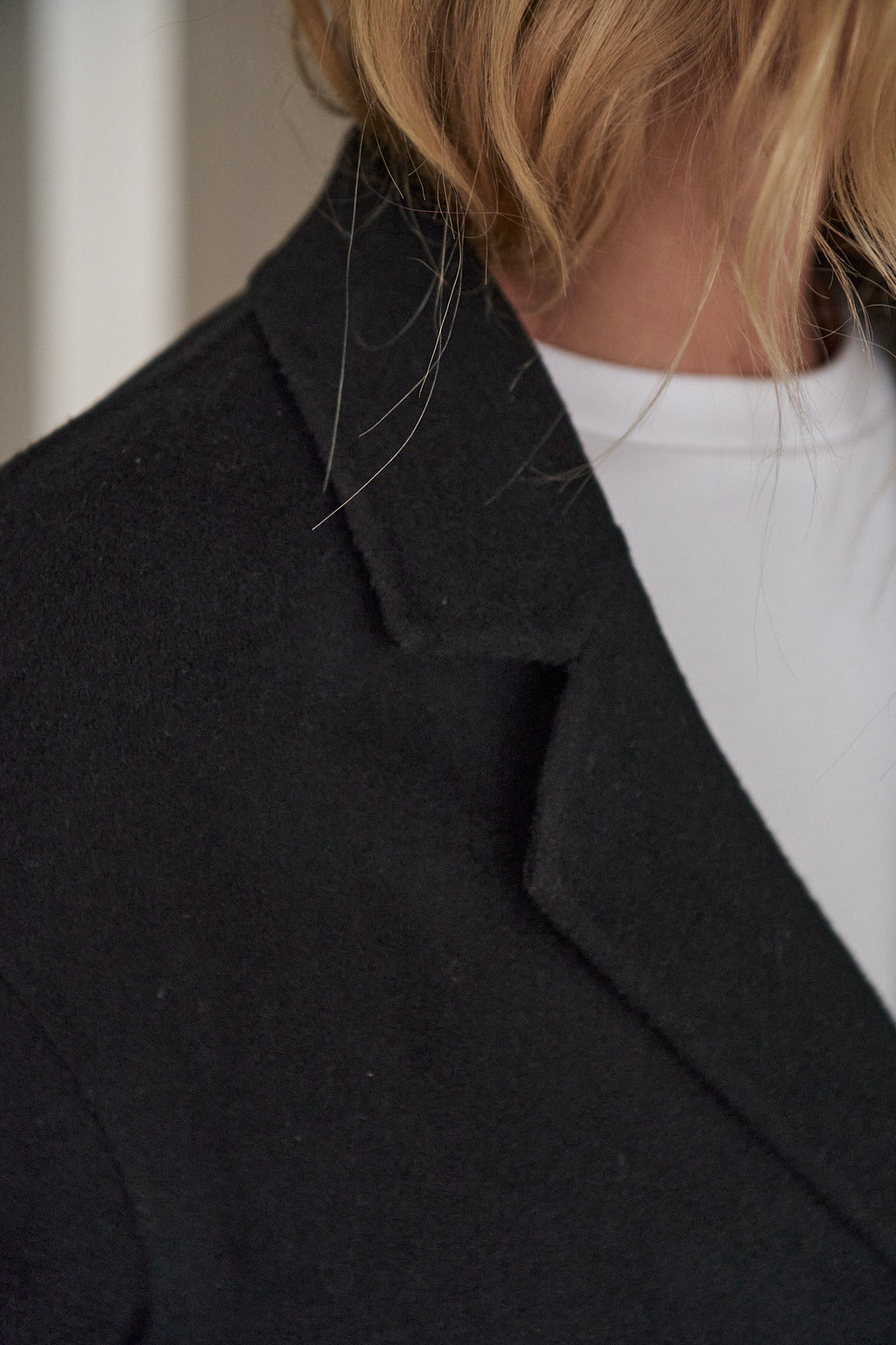 Double Breasted Wool Blazer - Black with a soft wool texture and a sharp lapel for a laid-back yet polished vibe.