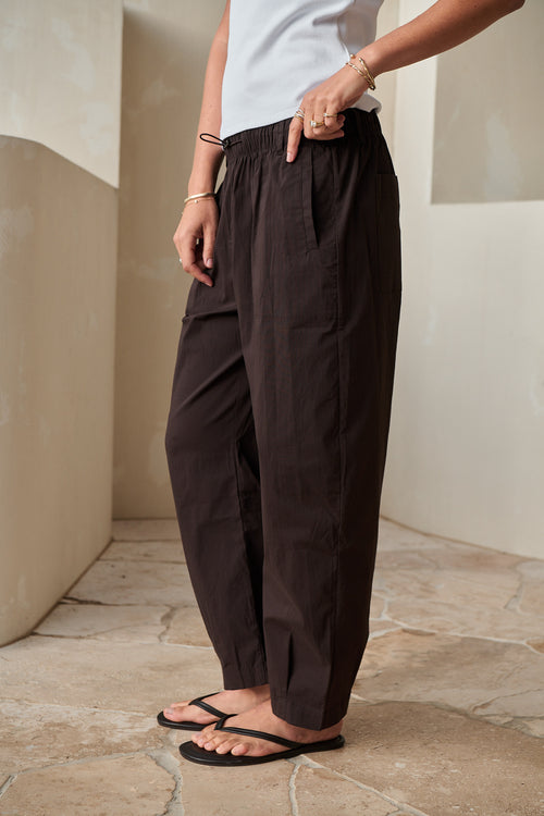 Nylon Barrel Pant - Chocolate in stretch nylon with an adjustable elastic waist and a rounded silhouette.