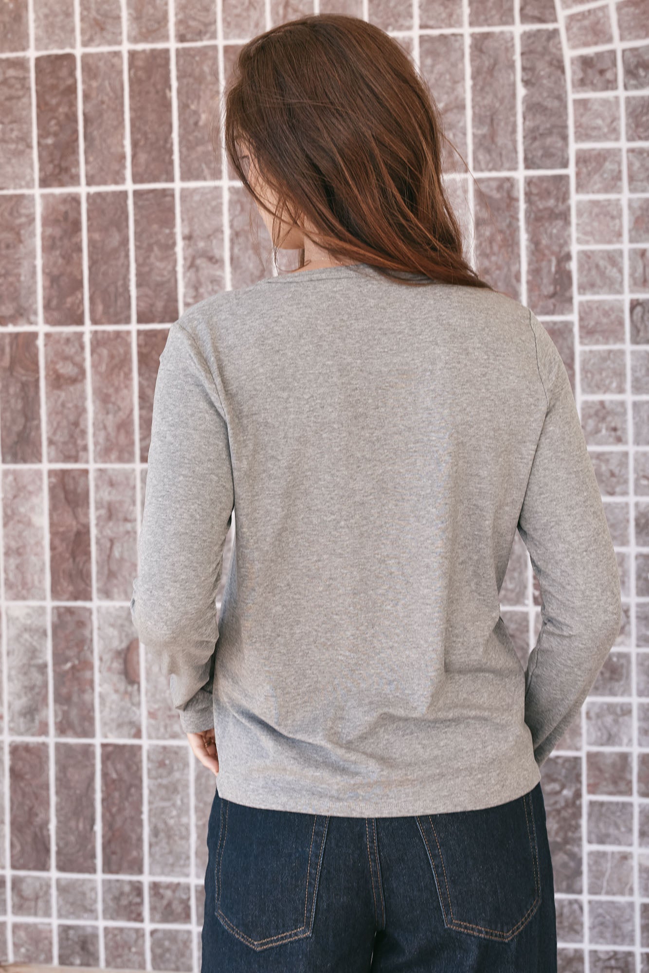 Basic Long Sleeve Top - Dark Grey in a soft, looser-knit fabric with extra room at the crew neck for easy layering.