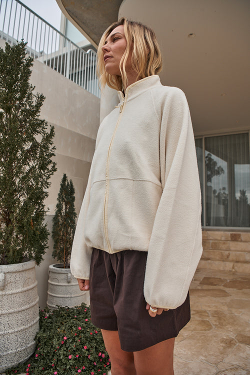 Fleece Zip Sweat - Bone in mid-weight fleece with a stand collar and bind detailing for a cozy yet polished look.