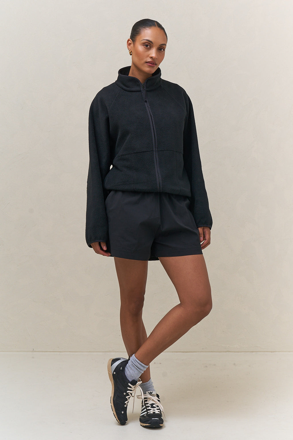 Fleece Zip Sweat - Black in mid-weight fleece with a stand collar and clean bind detailing for a sleek, casual finish.