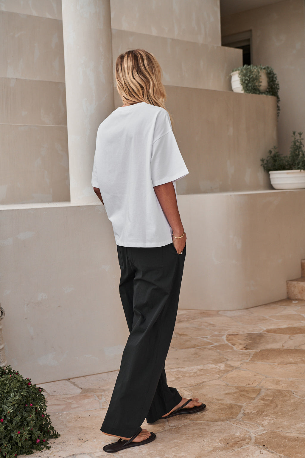 Wide-leg nylon track pant in black with a relaxed fit and subtle sheen for an easygoing, modern look.