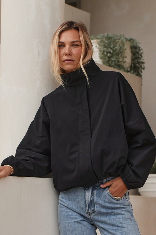 Nylon Track Jacket - Black with a high collar and elasticated cuffs, made from durable nylon fabric for a laid-back, timeless vibe.