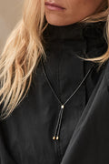 Stone Lariat Necklace - Black featuring delicate black beads with subtle gold accents for an understated finish.