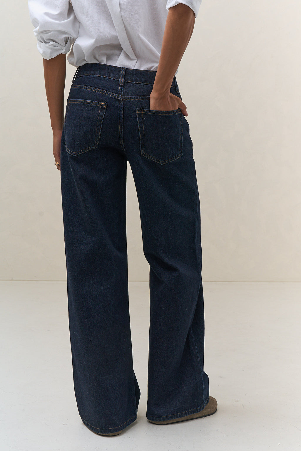 Mid Rise Wide Leg Jean - Indigo in rigid denim with a fitted waist and hips flowing into a sharp wide leg silhouette.