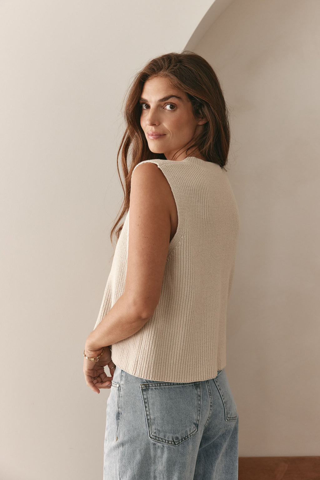 V-Neck Knit Vest in a soft beige cotton knit with a relaxed fit and subtle ribbing for layering over tees.