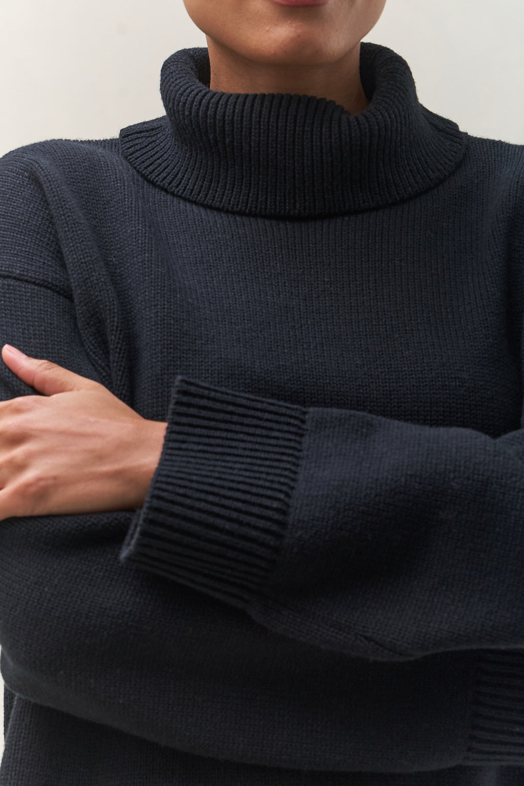 Merino Cotton Roll Neck Jumper - Black in soft knit with a chunky ribbed collar and cuff, perfect for laid-back layering.