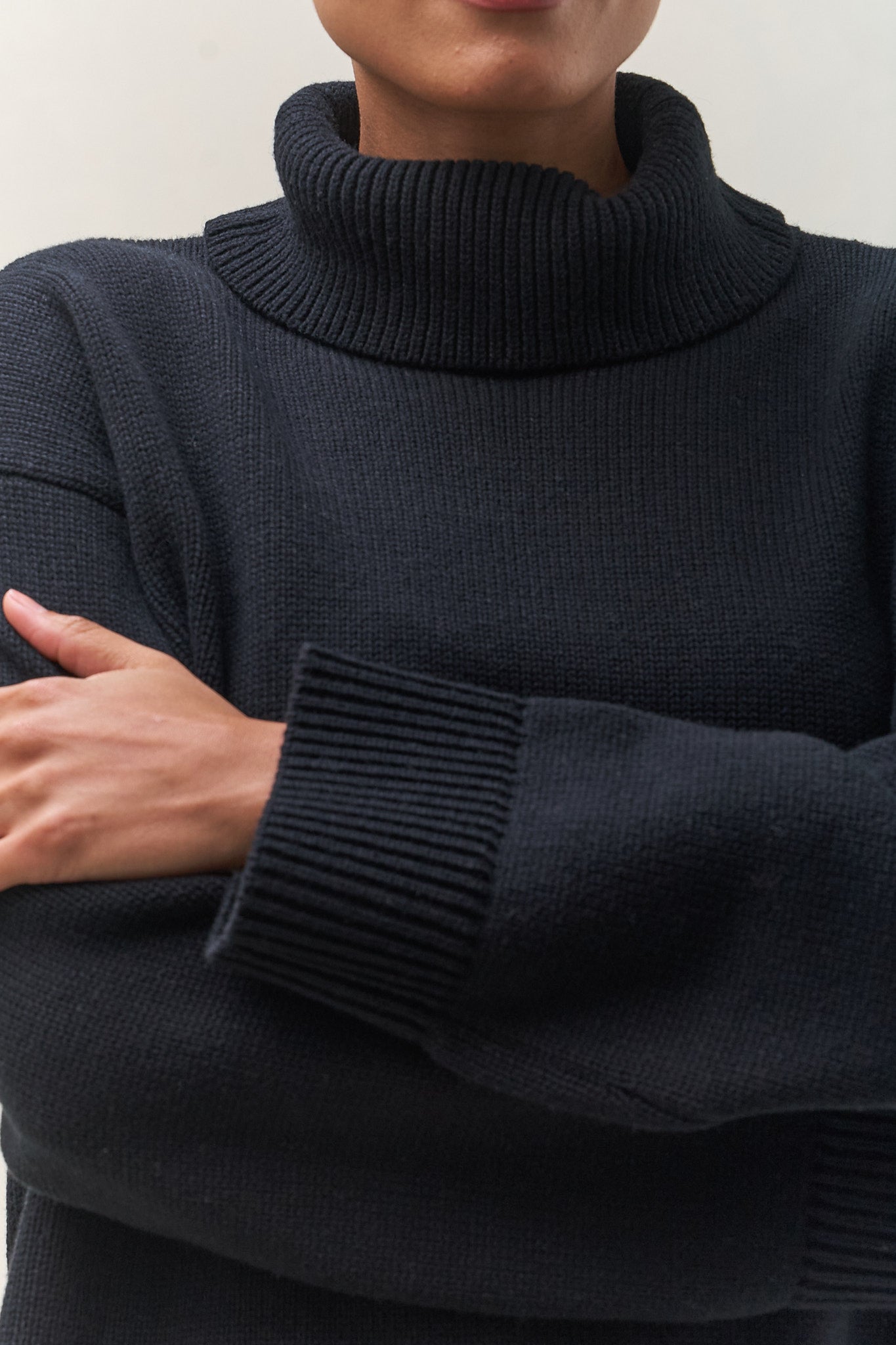 Merino Cotton Roll Neck Jumper - Black in soft knit with a chunky ribbed collar and cuff, perfect for laid-back layering.