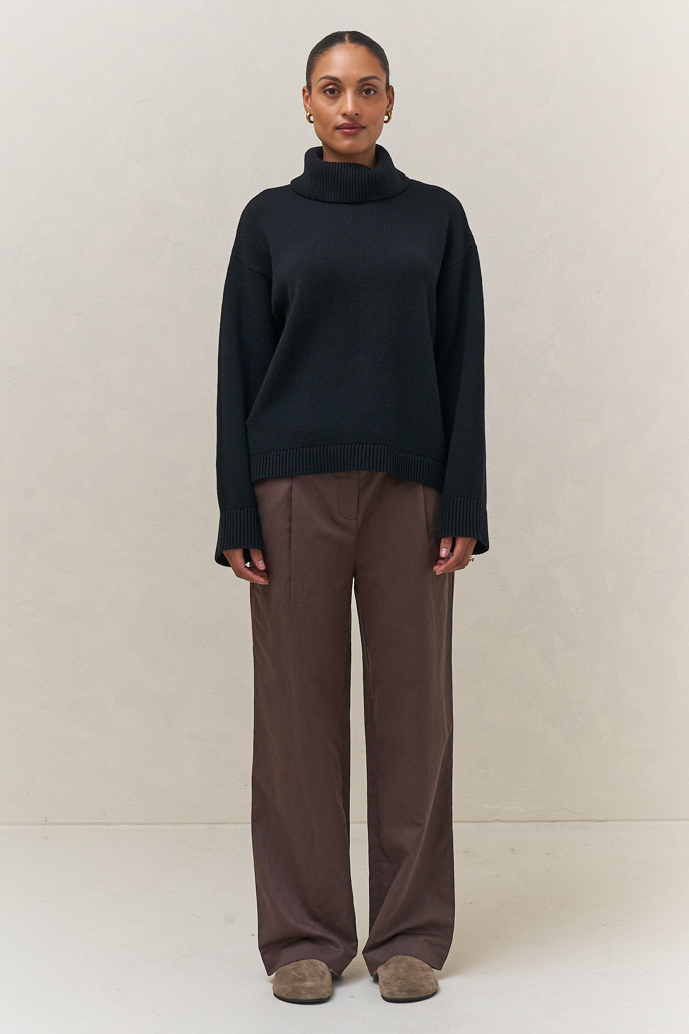 Merino Cotton Roll Neck Jumper - Black featuring a relaxed fit and cozy roll neck, made from durable merino cotton knit.
