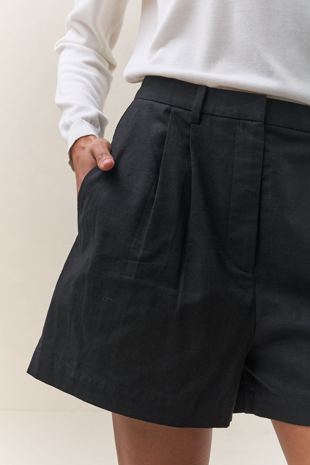 Tailored Linen Short - Black in breathable linen with pleat-front detail and a comfortable elastic back waistband for easy wear.